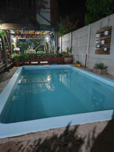 een blauw zwembad 's nachts met een terras bij Dormís La Cabaña in San Antonio de Areco