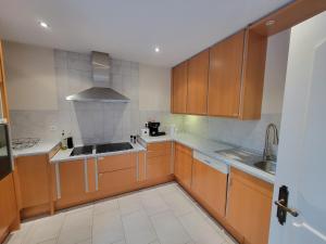 an empty kitchen with wooden cabinets and a sink at Ferienwohnung Stadtnähe in Calw in Calw +5 photos