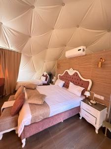 a bedroom with a large bed in a tent at Sunrise Luxury Camp in Wadi Rum