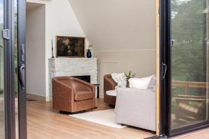 a living room with a couch and a chair and a fireplace at A-frame 10 Min to Downtown Durango in Durango