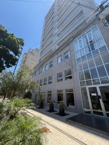 a large building with windows and plants in front of it at Capibara 6 - Vistas de Junin in Corrientes