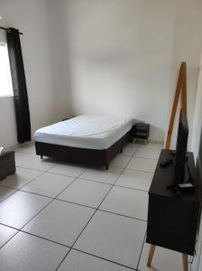 En eller flere senge i et værelse på Apartamento São Sebastião - 1,5km da balsa Ilhabela