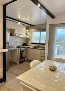 a kitchen with a table and some chairs and a table and a tableablish at Moderno DEPARTAMENTO temporal SAN JORGE in San Jorge