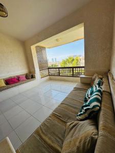 ein großes Schlafzimmer mit großem Bett und Balkon in der Unterkunft شاليه للايجار غرفتين مارينا 7 in El-Alamein