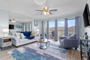 a living room with a couch and a table at Waterfront Summer Vacay Free Private Beach Chairs & Umbrella Sleeps 5 in Destin +29 photos