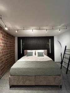 a bedroom with a large bed and a brick wall at Ein Traum im Turm, historischer Wasserturm Worms in Worms