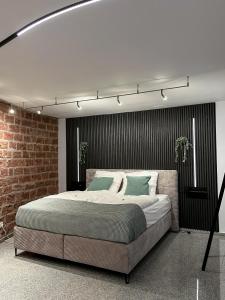 a bedroom with a large bed in a brick wall at Ein Traum im Turm, historischer Wasserturm Worms in Worms