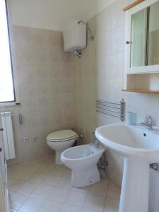 a white bathroom with a toilet and a sink at Agriturismo Sila in Termoli +20 photos