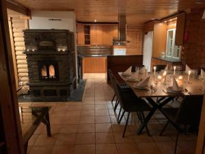 a dining room with a table and a fireplace at Villa Sofia in Otalampi
