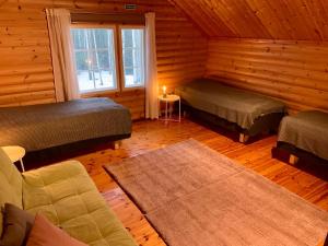 OtalampiVilla Sofia的小屋内带两张床和一张沙发的房间