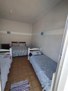 une chambre avec trois lits dans une pièce dans l'établissement Suite Big Tower, à Penha