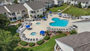 an aerial view of a swimming pool at a resort at Waterfront Summer Vacay Free Private Beach Chairs & Umbrella Sleeps 5 in Destin