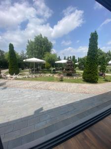 a view of a park from a window at Hotel Restaurant Arena in Kastriot
