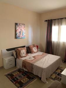 una camera da letto con un letto e un quadro sul muro di Keur Antou a Dakar