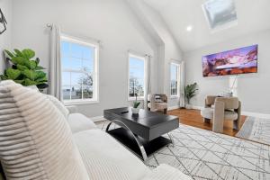 a living room with a couch and a table at 4 BR • Vaulted Living • Sleeps 11 in Jersey City
