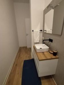 a bathroom with a white sink and a mirror at Oltremare in Molfetta