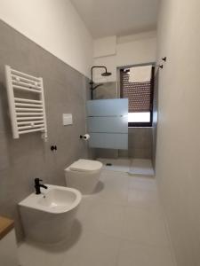 a bathroom with a toilet and a sink at Oltremare in Molfetta