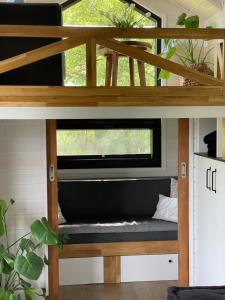 a tiny house with a window and a bench at Tiny Silent House in Zblewo