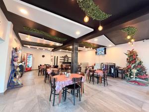 a restaurant with tables and chairs and a christmas tree at Hotel Las Vegas in Matamoros