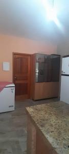 a kitchen with a refrigerator and a counter top at Casa sitio , Elias Fausto Campinas in Elias Fausto
