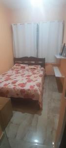 a bedroom with a bed with a red comforter at Casa sitio , Elias Fausto Campinas in Elias Fausto +22 photos