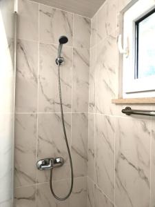 a shower with a shower head in a bathroom at Studio in Barbéns, Miranda do Corvo - Casa 99 in Miranda do Corvo +33 photos
