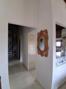 a hallway with a mirror on a wall at Chalé 4 Quartos Casa Jasmin in Chã Grande