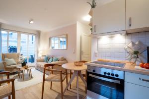 a kitchen and living room with a table and a stove at _ARW3_ _ Ferienwohnung Kossmann in Niendorf