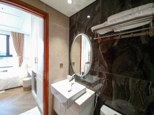a bathroom with a sink and a mirror at Phuc Thang Boutique Seaview Hotel in Phu Quoc