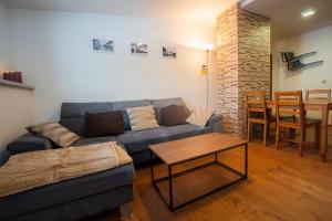 a living room with a couch and a table at Apartmán Pivoňka in Kvilda