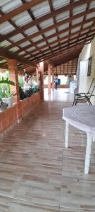 a hallway with a table and chairs in a building at Casa sitio , Elias Fausto Campinas in Elias Fausto