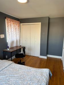 a bedroom with a bed and a desk and a window at R2 Near to Towson and Morgan University in Parkville +3 photos