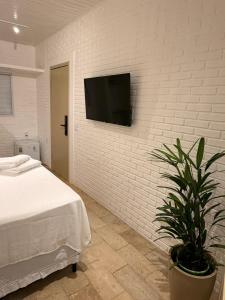 Et tv og/eller underholdning på Kanga Suítes - Aquário