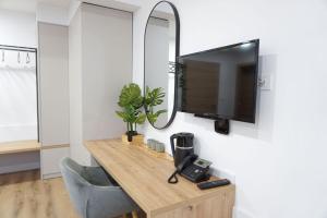 a room with a desk with a tv and a mirror at Gostisce Ulipi in Slovenske Konjice