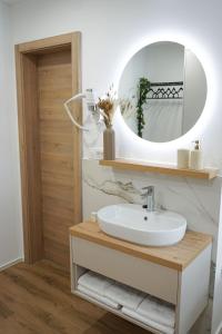 a bathroom with a sink and a mirror at Gostisce Ulipi in Slovenske Konjice +39 photos