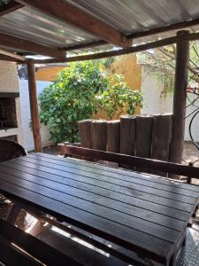 a wooden picnic table sitting on a patio at Ebenezer in Playa Hermosa +3 photos