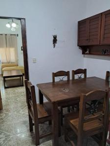a wooden table and chairs in a room at Ebenezer in Playa Hermosa