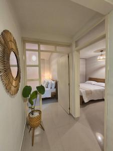 a bedroom with a bed and a mirror and a plant at Casa Vacacional para 15 Personas con Jacuzzi Privado A 20 min de Salento by Molca Travel in Armenia