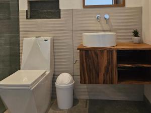 a bathroom with a sink and a toilet at Mystica in Playa Avellana