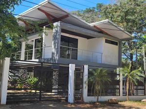a house with a fence in front of it at Mystica in Playa Avellana