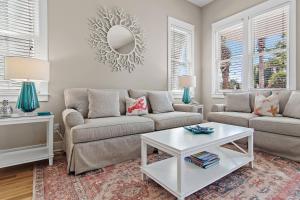 a living room with two couches and a table at Shore Fun At Destin Pointe Resort in Destin
