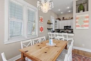 a dining room with a wooden table and white chairs at Shore Fun At Destin Pointe Resort in Destin +33 photos
