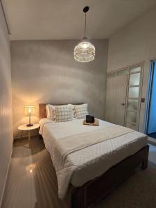 a bedroom with a large bed with a lamp on it at Casa Vacacional para 15 Personas con Jacuzzi Privado A 20 min de Salento by Molca Travel in Armenia