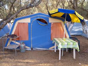 a blue and orange tent with a table in front of it at Camping Chania in Kato Daratso