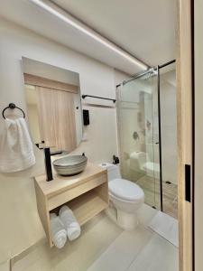 a bathroom with a toilet and a glass shower at Casa Kereht Cali in Cali +43 photos