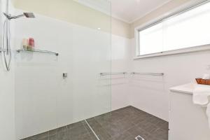 a bathroom with a glass shower stall and a sink at Glandore Estate in Pokolbin +23 photos
