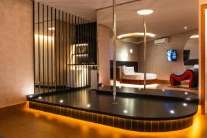 a hotel room with a table and a bed at Sensações Suítes - Adults Only in Arraial d'Ajuda