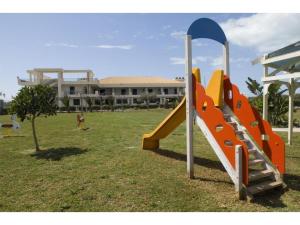 a playground with a slide in front of a building at Apartment in Scoglitti, Sicily in Scoglitti