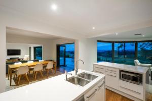 a kitchen and dining room with a table and chairs at Hahndorf Farm Barn in Hahndorf