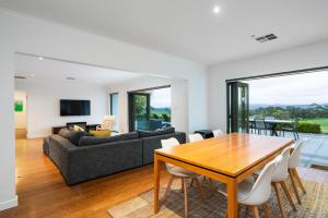 a living room with a table and a couch at Hahndorf Farm Barn in Hahndorf